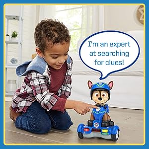 Kid pushes pup tag button and toy says: I’m an expert at searching for clues!
