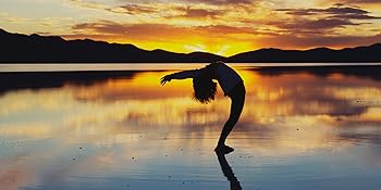 Stock photo of human stretching with pictureqsue sunrise or sunset in distance