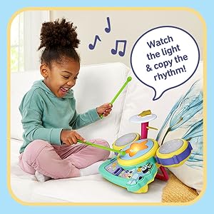 Kid follows along and plays the drum pads and cymbals when they light up.