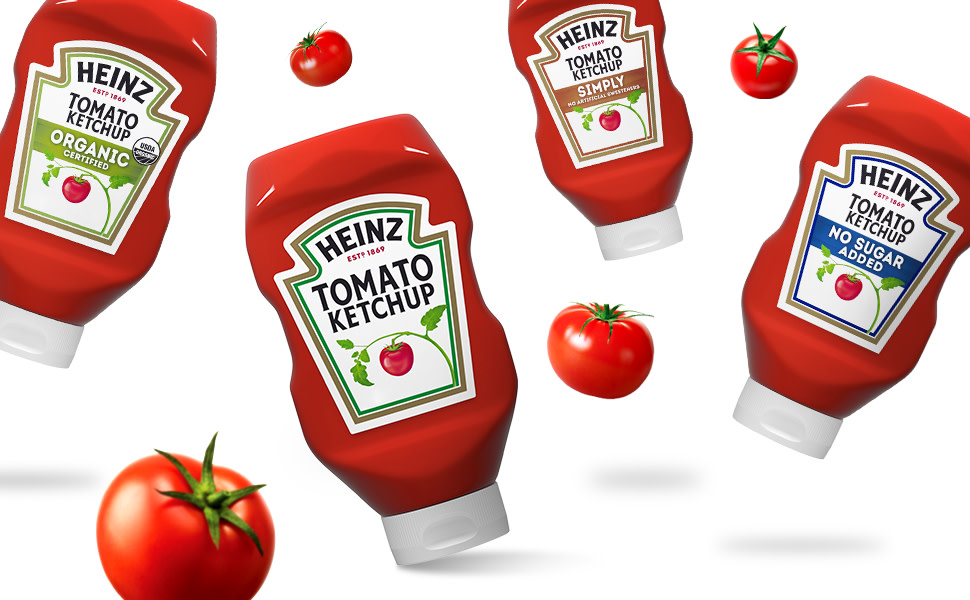 Photo of Heinz Tomato Ketchup bottles falling next to red ripe tomatoes with a white background.