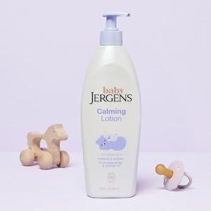 Bottle of Baby Jergens lotion next to rubber ducky.