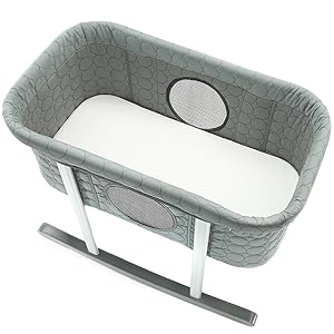 A photo of our rocking bassinet with included bassinet mattress pad