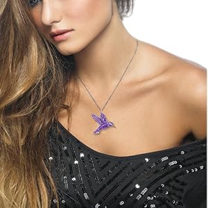 Model adorning the hummingbird necklace in 925 sterling silver - purple polymer clay pattern choice 