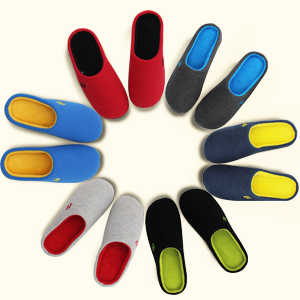 A circle of two-tone memory foam slippers by RockDove, including men's and women's styles.