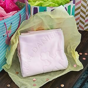 Personalized pink baptism blanket in gift wrap with presents