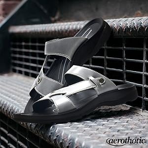 A grey leather sandal with arch support for women, designed for comfort and to alleviate foot pain like plantar fasciitis.