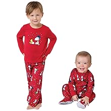 Toddler and baby wearing matching Snoopy Christmas PJs