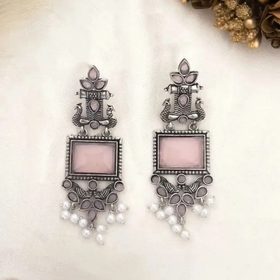 Side view of oxidized silver pink stone pearl drop earrings